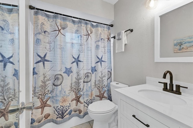 bathroom with toilet, vanity, tile patterned floors, and curtained shower