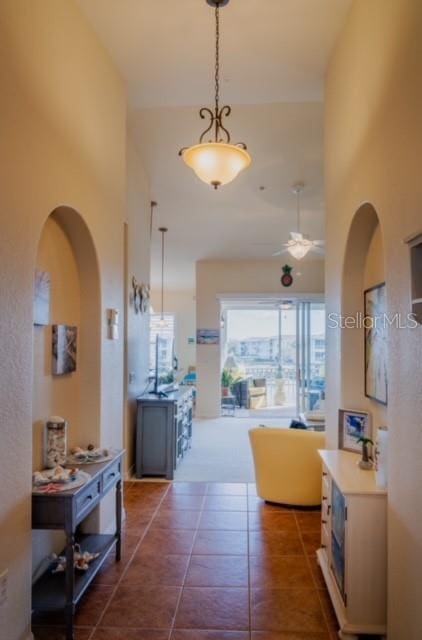 hallway featuring dark tile patterned floors