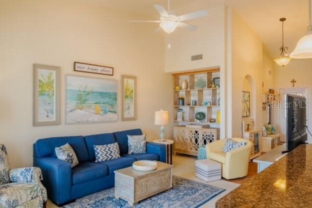 living room with high vaulted ceiling and ceiling fan