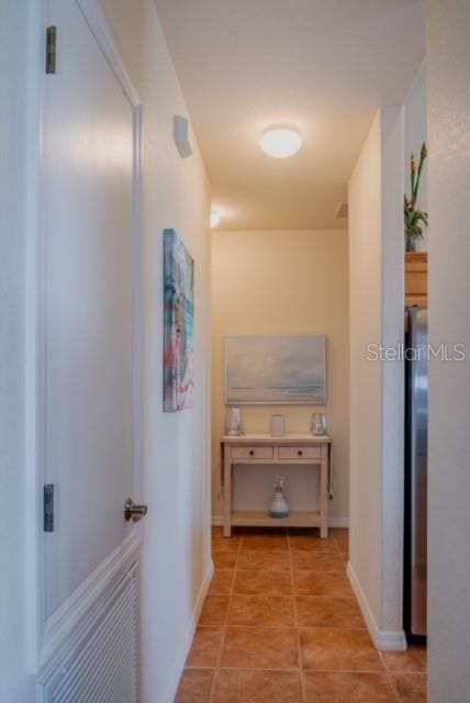 hall with light tile patterned flooring