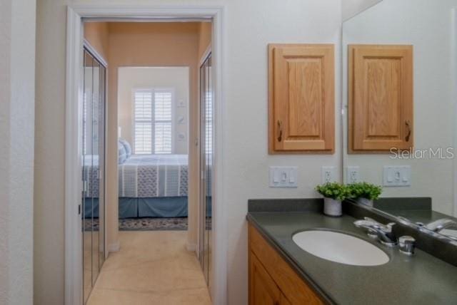 bathroom featuring tile patterned flooring and vanity