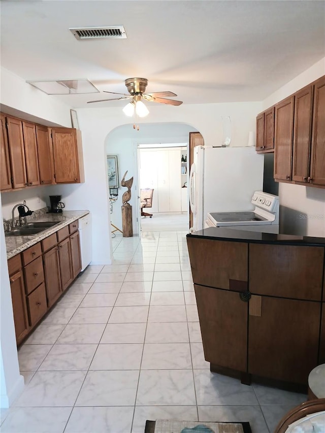 kitchen featuring light tile patterned flooring, electric stove, ceiling fan, and sink