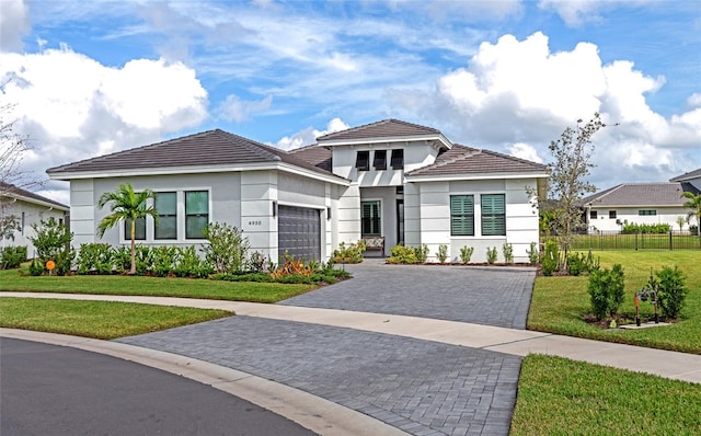 view of front facade with a garage and a front lawn