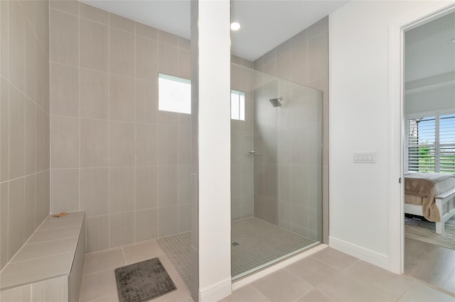 bathroom featuring tile patterned floors and a tile shower