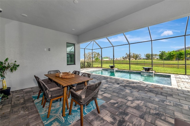 view of swimming pool with glass enclosure, a patio area, a yard, and pool water feature