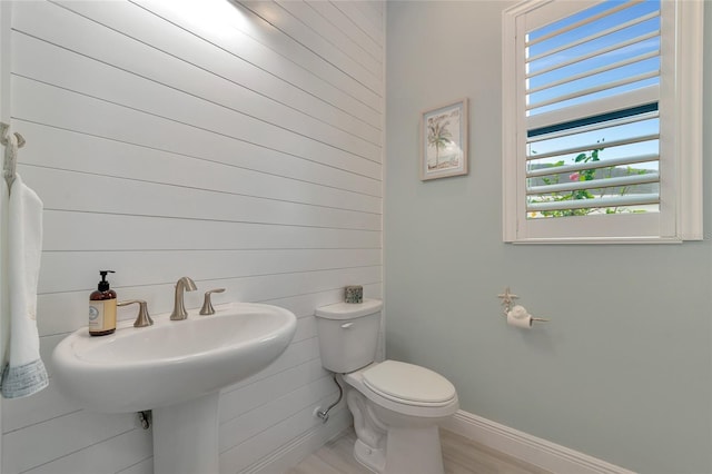 bathroom with sink, hardwood / wood-style floors, and toilet