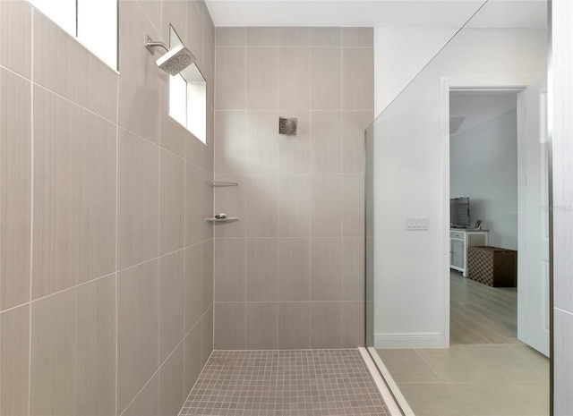 bathroom featuring tile patterned flooring and tiled shower