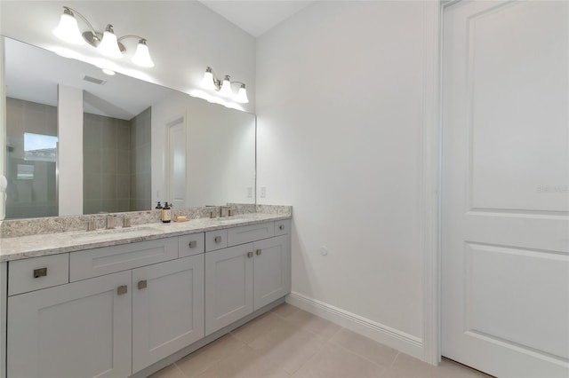 bathroom with tile patterned flooring and vanity