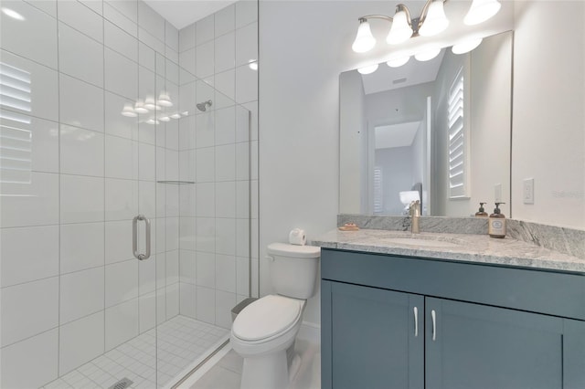 bathroom with vanity, a shower with shower door, and toilet