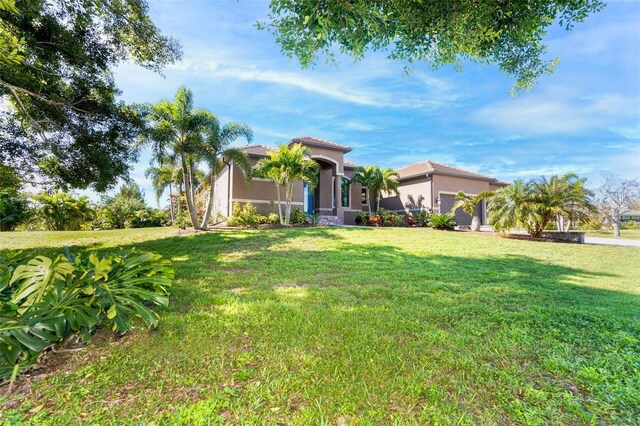 mediterranean / spanish house featuring a front yard