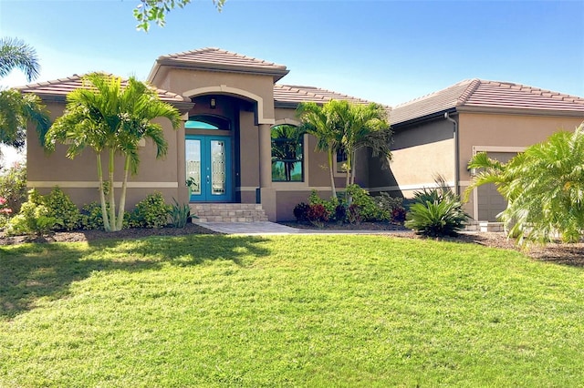 mediterranean / spanish-style house with a front yard and a garage