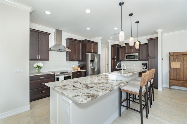 kitchen featuring stainless steel appliances, a breakfast bar, tasteful backsplash, wall chimney exhaust hood, and a large island