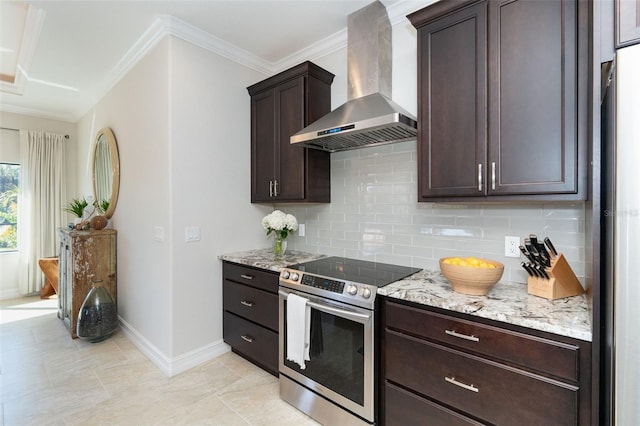 kitchen featuring light stone counters, tasteful backsplash, stainless steel range with electric stovetop, dark brown cabinets, and wall chimney range hood