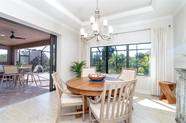 dining space with ceiling fan with notable chandelier, a raised ceiling, and crown molding