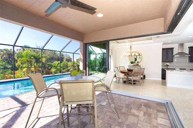 exterior space featuring a patio, ceiling fan, and glass enclosure