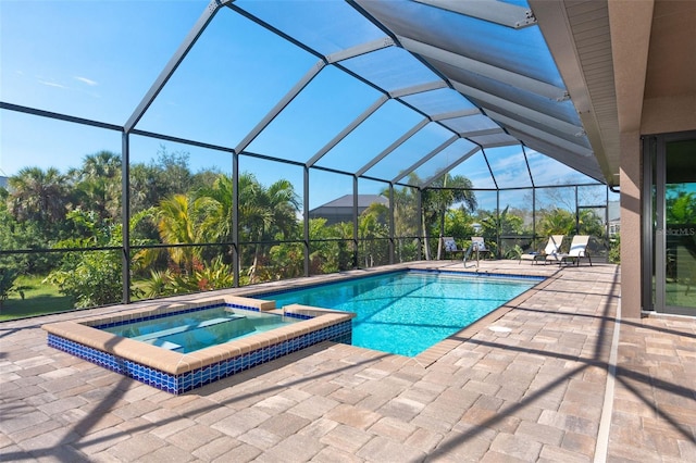 view of pool with a lanai, an in ground hot tub, and a patio area