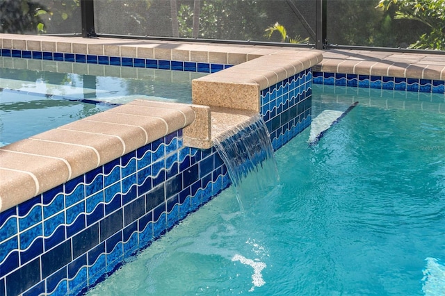 view of swimming pool with pool water feature