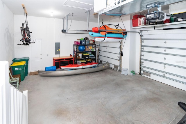 garage with electric panel and a garage door opener