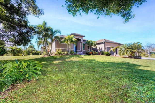 mediterranean / spanish house with a front yard