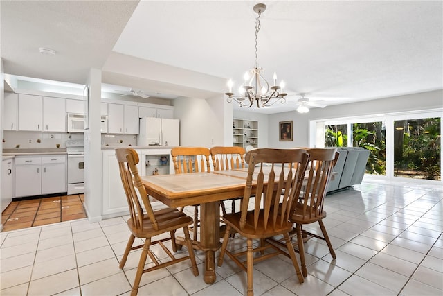 tiled dining area with ceiling fan with notable chandelier