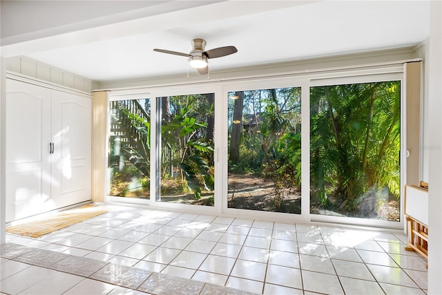 doorway to outside featuring light tile patterned flooring and ceiling fan