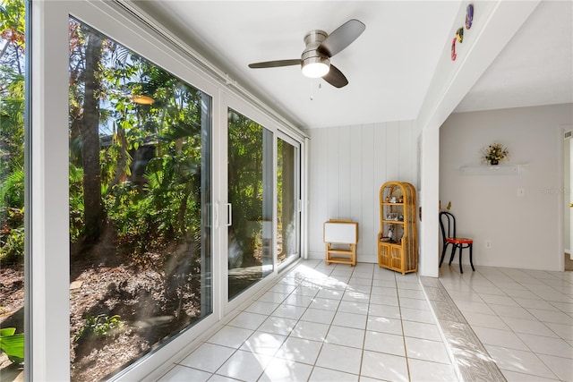 sitting room featuring light tile patterned floors, a wealth of natural light, and ceiling fan