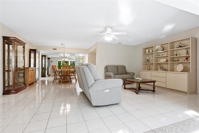 living room featuring light tile patterned flooring and ceiling fan with notable chandelier