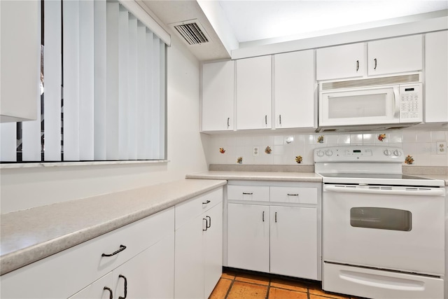 kitchen with white cabinetry, light tile patterned floors, white appliances, and decorative backsplash