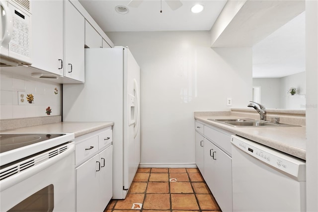 kitchen with sink, white appliances, and white cabinets