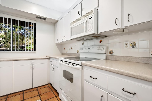 kitchen with tasteful backsplash, white cabinetry, and white appliances