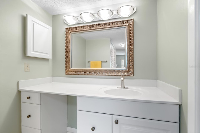 bathroom featuring vanity and a textured ceiling