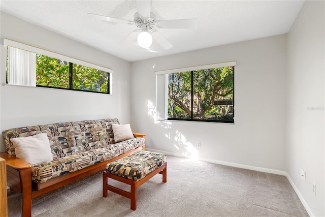 carpeted living room featuring ceiling fan