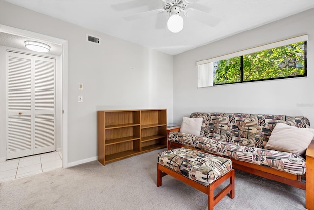 carpeted living room featuring ceiling fan