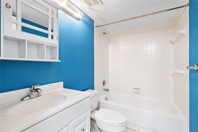 full bathroom with tiled shower / bath, vanity, and toilet