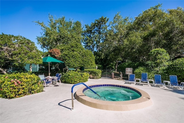 view of pool featuring a hot tub and a patio area