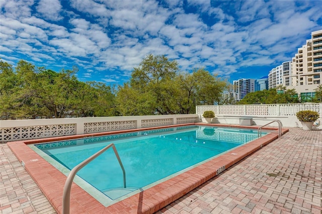 view of swimming pool featuring a patio area