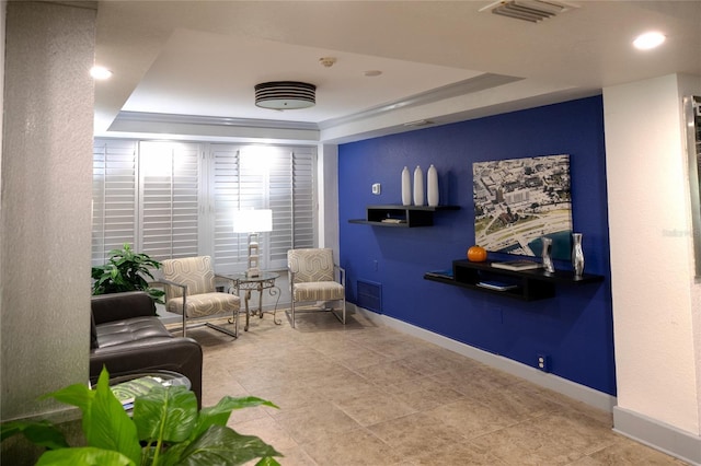 living area featuring a raised ceiling