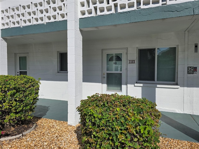 view of exterior entry featuring a balcony