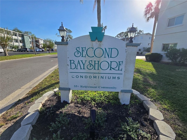 community / neighborhood sign with a lawn