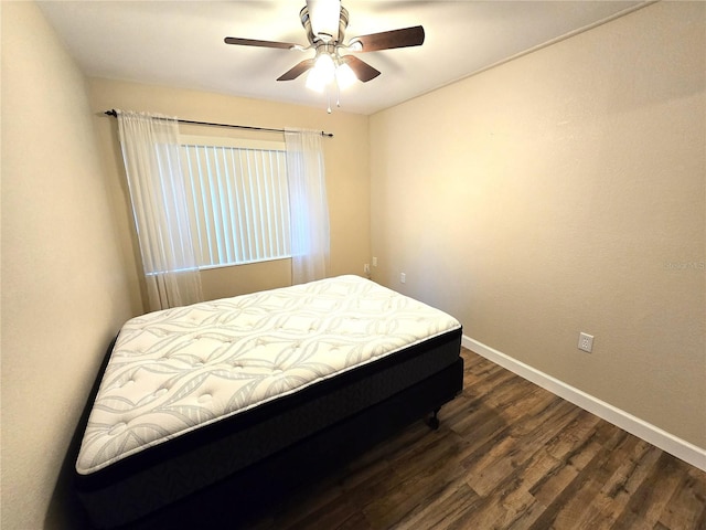 bedroom with ceiling fan and dark hardwood / wood-style floors