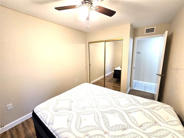 bedroom with a closet, ceiling fan, and dark hardwood / wood-style floors