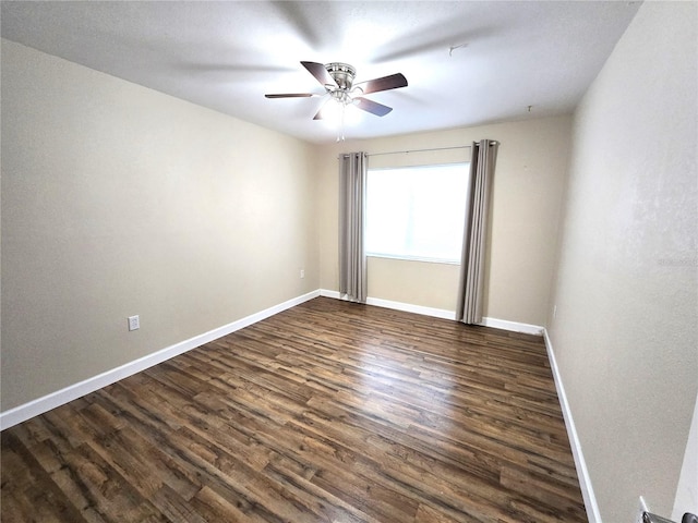 spare room with dark hardwood / wood-style floors and ceiling fan