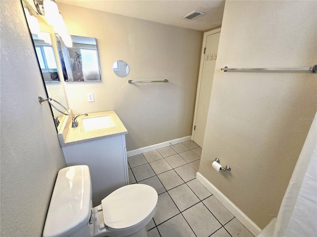 bathroom with vanity, tile patterned floors, and toilet