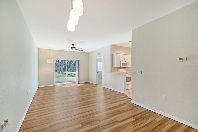 unfurnished living room featuring light wood-type flooring and ceiling fan