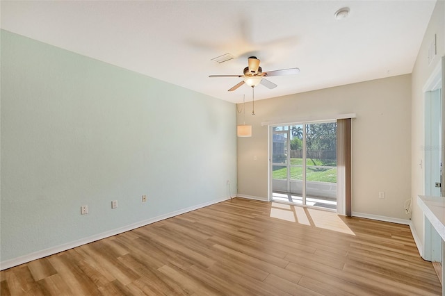 spare room with light wood-type flooring and ceiling fan