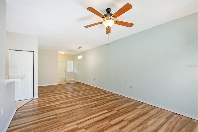 unfurnished room with ceiling fan and light hardwood / wood-style flooring