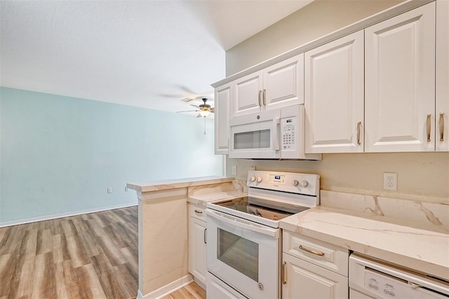 kitchen featuring white appliances, white cabinets, ceiling fan, and kitchen peninsula