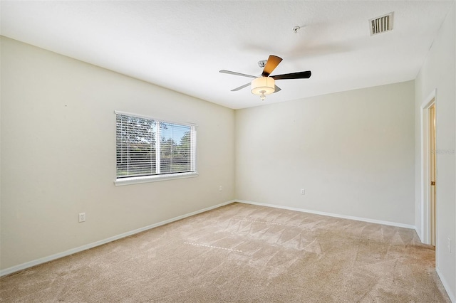 carpeted spare room with ceiling fan