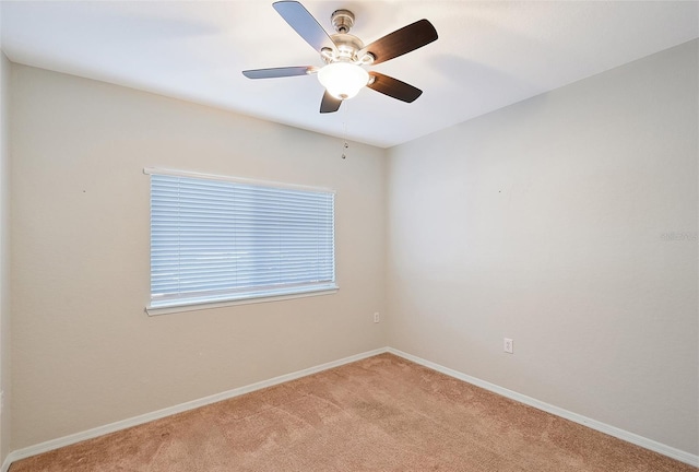 spare room with ceiling fan and light carpet