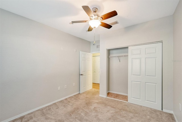 unfurnished bedroom featuring a closet, light carpet, and ceiling fan